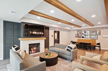 a living room with a fireplace and a television